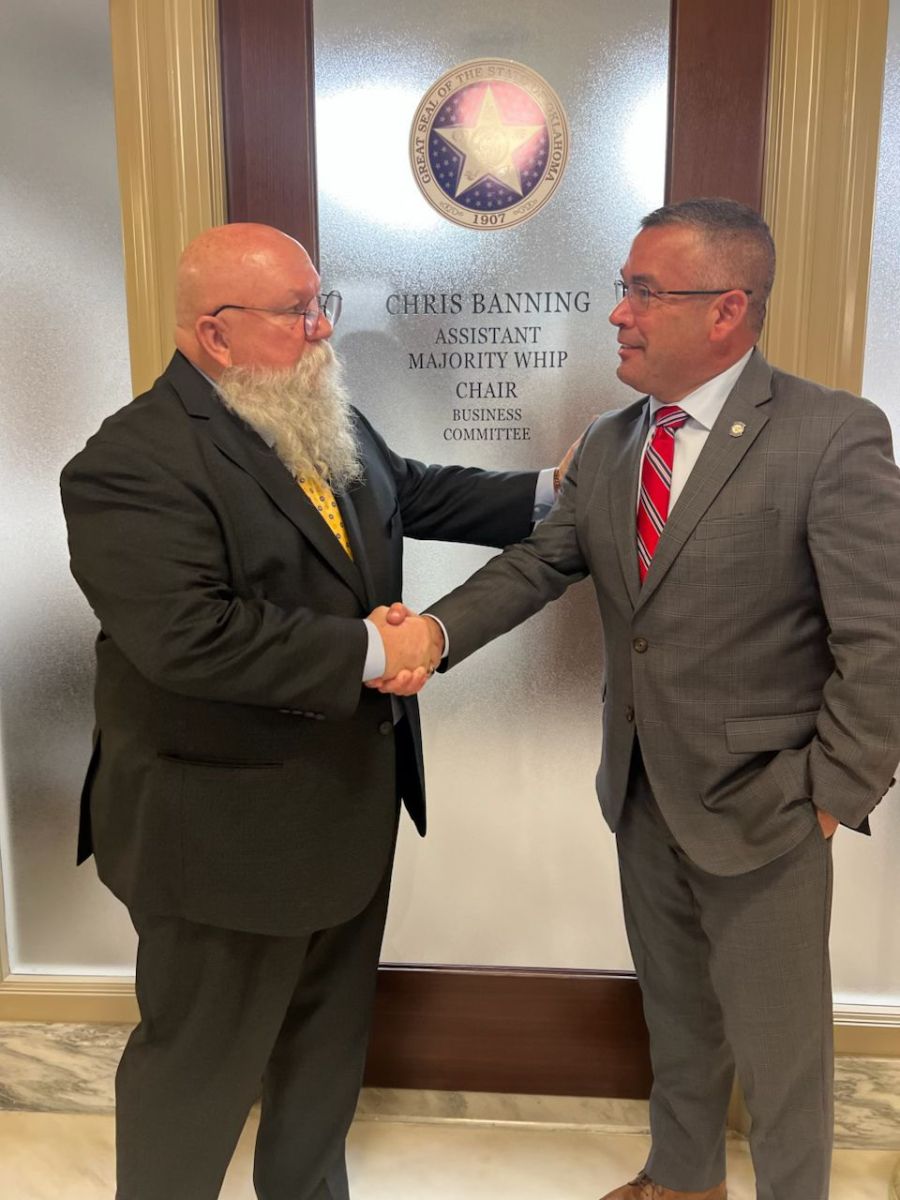 Mayor Roger shaking hands with Chris Banning